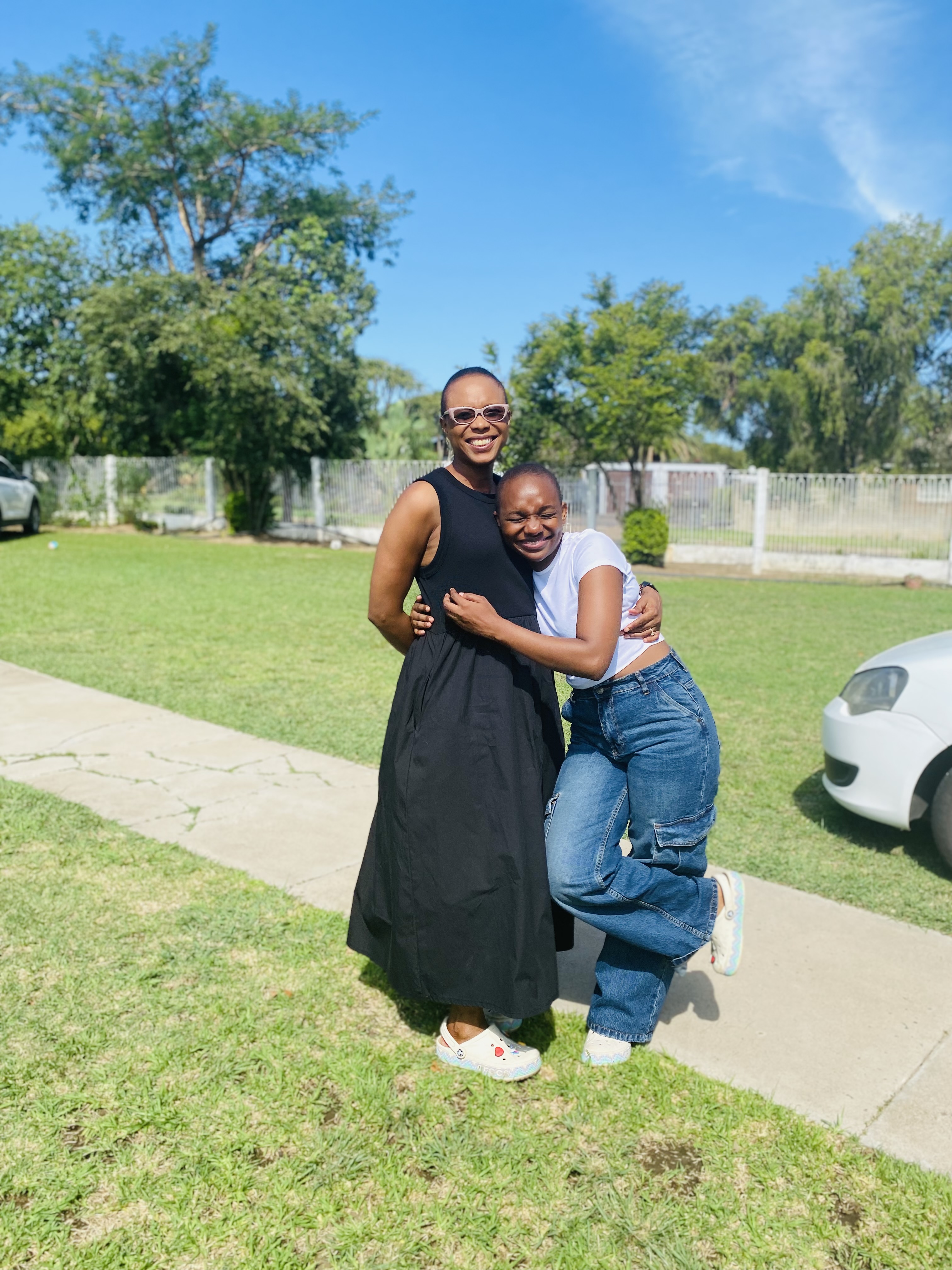 Mom hugging her daughter outdoors