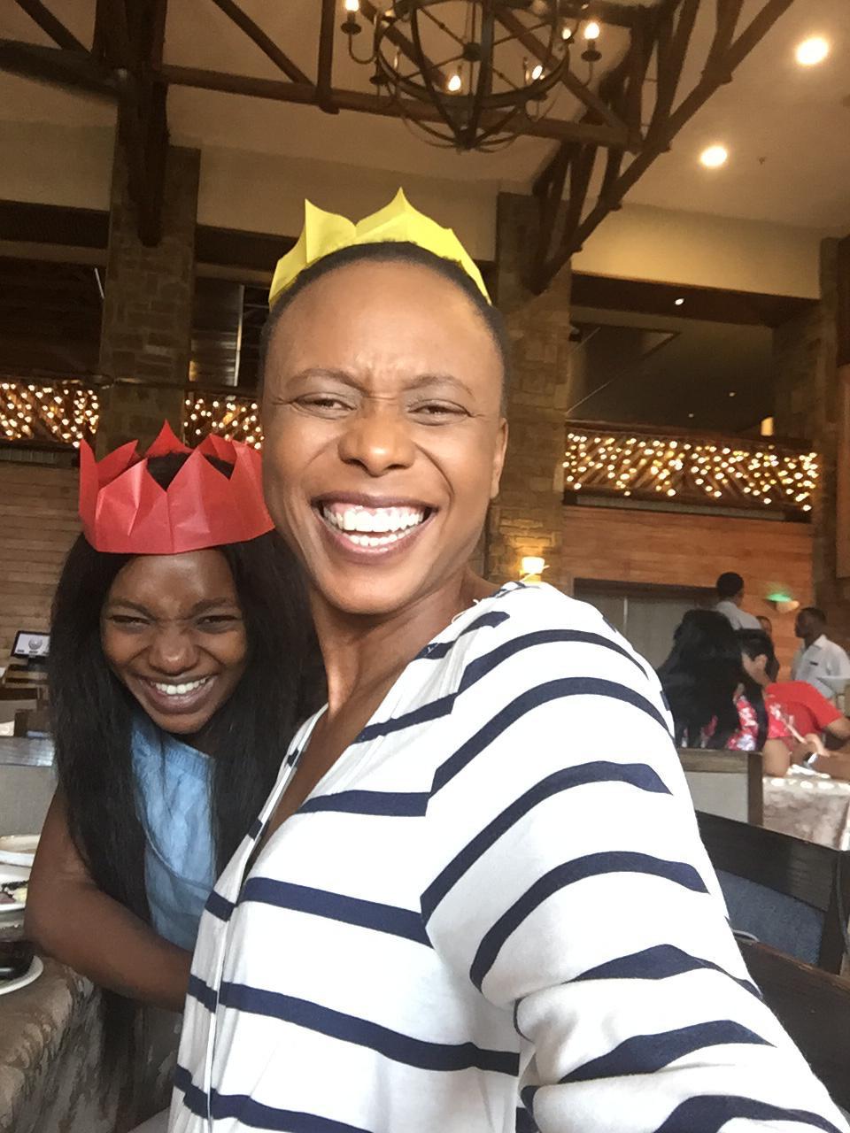 Mom and her daughter wearing paper party crowns